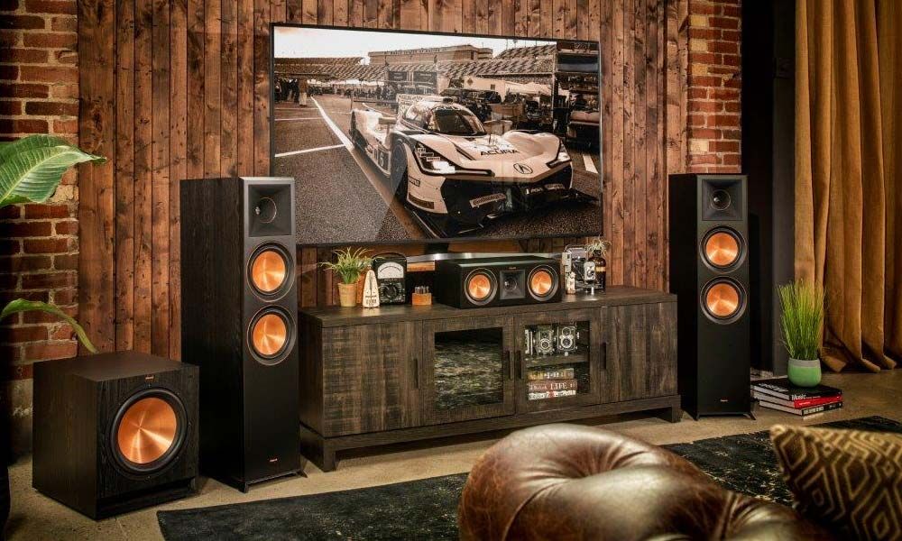 klipsch speakers in a wooden room with a tv