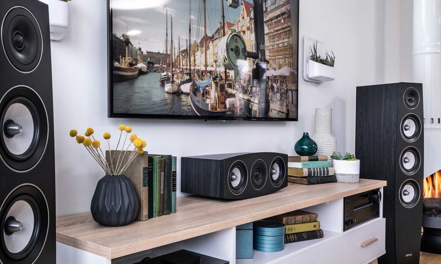klipsch speakers in a room with a tv on the wall